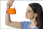 Close-up of a female technician holding a conical flask