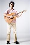 Portrait of a teenage boy playing the guitar