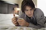 Close-up of a young man playing with playing cards