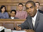 Portrait of a male lawyer sitting in a courtroom