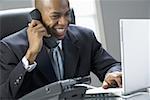 Close-up of a businessman smiling and talking on the phone