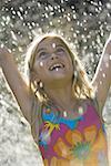 Close-up of a girl in a water sprinkler