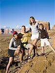 Family posing outdoors with rock formations