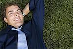 Portrait of a businessman lying on a lawn