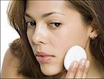 Close-up of a woman applying face powder