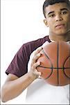 Portrait of a young man holding a ball