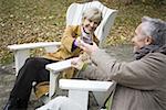 High angle view of a mature couple toasting with glasses of wine
