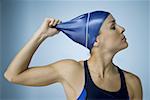 Close-up of a woman pulling off her swim cap