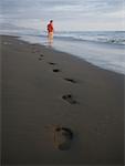 Rear view of a man walking on the beach