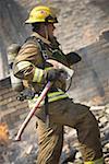 Profile of a firefighter holding an axe
