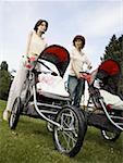 Low angle view of two mannequins portraying mothers pushing prams