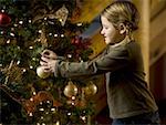 Girl with Christmas bauble and Christmas tree