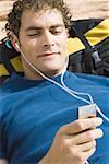 High angle view of a young man listening to music