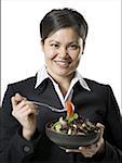 Portrait of a young woman holding a salad