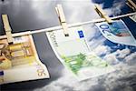 Close-up of Euro banknotes pegged to a clothesline