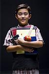 Portrait of a boy holding books