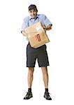 Portrait of a mailman holding a damaged package