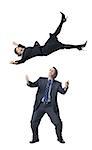 Businesswoman falling on businessman