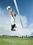 Soccer goalkeeper making diving save