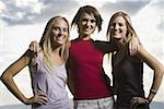 Portrait of three young women smiling