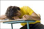 Close-up of a teenage boy sleeping on a desk