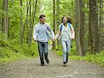 Young couple running and holding hands