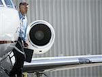 Profile of a businessman exiting an airplane