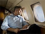 A businessman looking through an airplane window