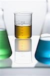 Close-up of beakers with colored liquid