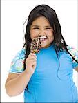 Overweight young girl eating ice cream bar