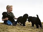 Boy with puppies outdoors