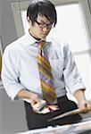 Close-up of a businessman looking down at color swatches