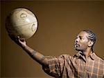 African American man holding a globe