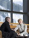 Man and woman chatting in a ski lodge