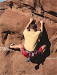Rear view of a man rock climbing