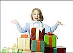 Portrait of a girl standing behind a stack of gifts