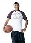 Portrait of a young man holding a basketball