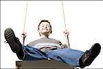 Low angle view of a boy on a swing