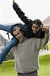 Portrait of a father carrying his daughter on his shoulders