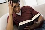 High angle view of a man reading a book