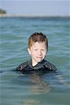 Portrait of a boy smiling in the sea