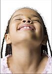 Close-up of a girl smiling with her eyes closed