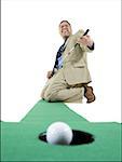 Businessman playing golf on artificial turf