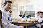 Family sitting at a dining table