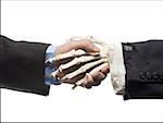 Businessman shaking hands with skeleton