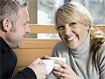 Close-up of an adult couple drinking hot beverages