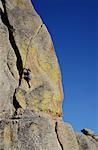 Rear view of a woman rock climbing