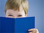 Boy reading hardcover book