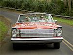 Young couple in a convertible car