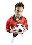 Portrait of a young man holding a soccer ball